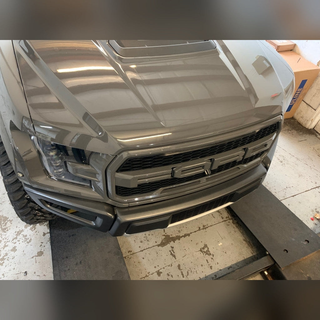 2018-2020 Ford F-150 Raptor 3/4" front bumper spacer kit — installed view 2 showing bumper and tire clearance