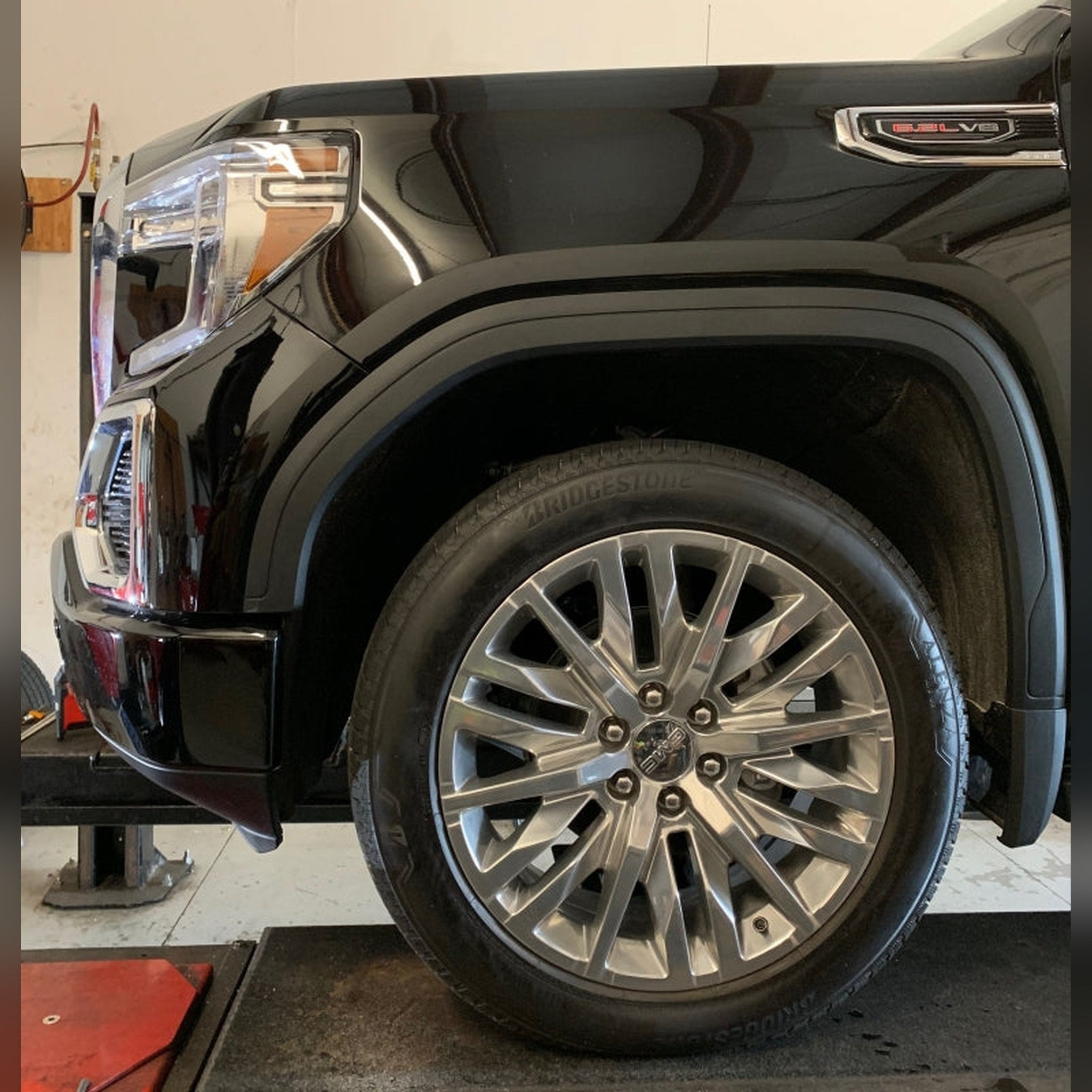2019+ GMC Sierra 1500 3/4" front bumper spacer kit — installed view 3 showing bumper and tire clearance